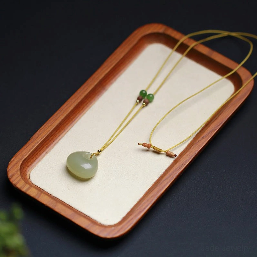 Hetian jade good luck pendant with cord detail, yellow adjustable necklace string with spacer beads handcrafted presentation