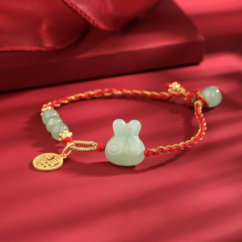 Hetian jade rabbit red string bracelet angled view showing fu tag and jade bead composition