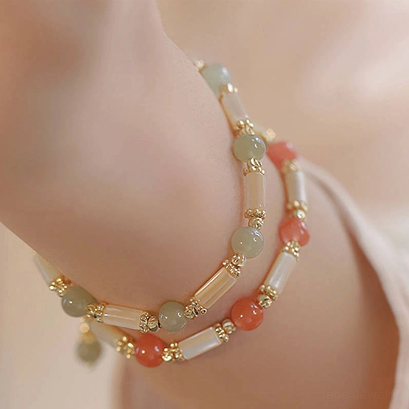Double-layer hetian jade and red agate blessing bracelet worn on wrist with gold accents, overhead view showcasing daily style versatility