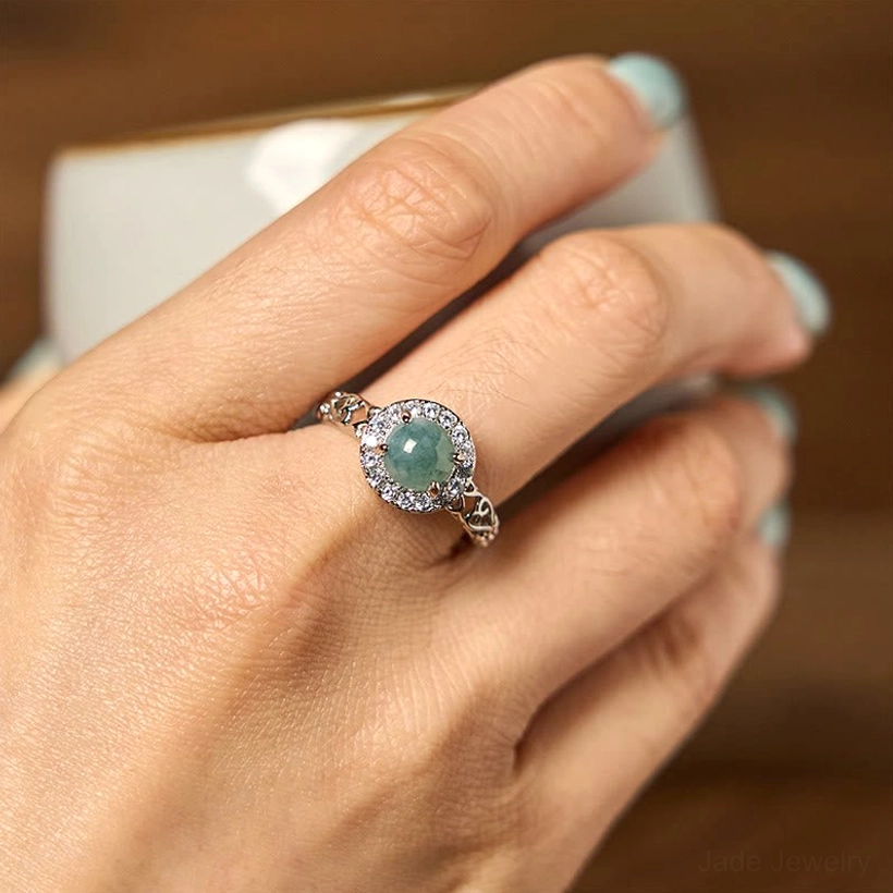 Hetian jade ruyi ring worn on finger, close-up lifestyle shot showing authentic wear and design