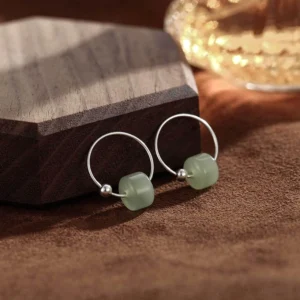 Hetian jade sterling silver hoop earrings front view showing light green jade beads on polished silver hoops