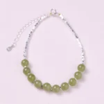 Hetian jade sterling silver prosperity bracelet full overhead view light green jade beads with 925 silver adjustable chain