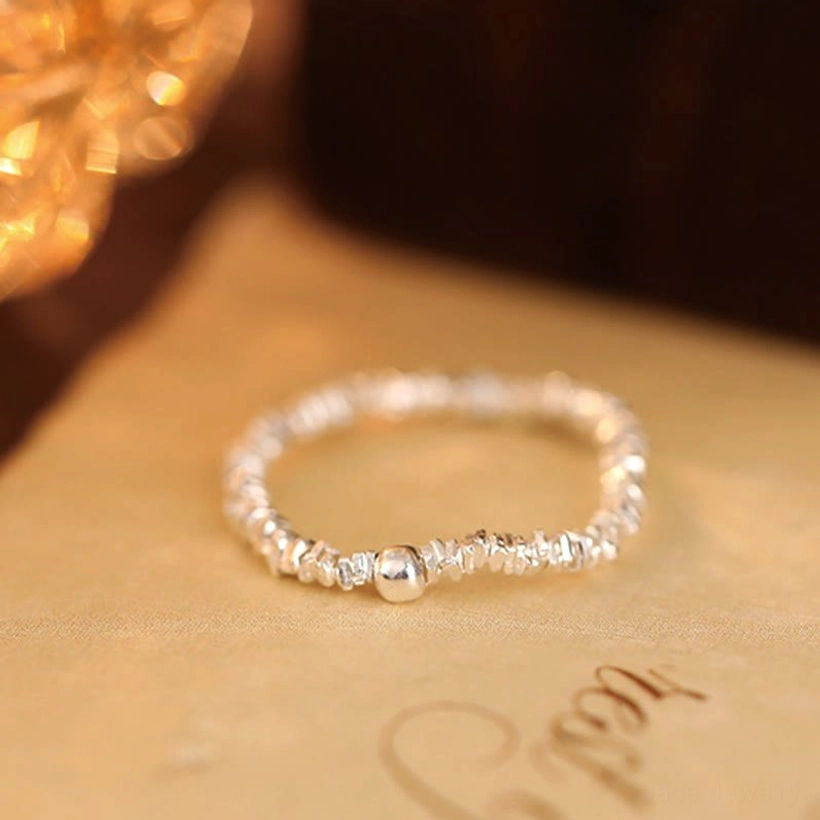 Single Hetian jade bead 925 sterling silver elastic ring on warm fabric background