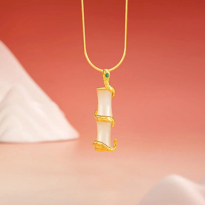 Hetian jade snake bamboo pendant with 925 sterling silver - front close-up showing coiled snake design and green gem accent on white jade