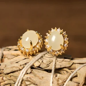 Natural Hetian jade stud earrings with gold halo setting and cubic zirconia accents, front top view