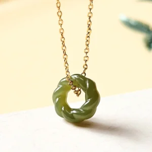Hand-carved Hetian jade twisted pendant necklace with sterling silver or copper chain, front close-up view showing deep green celadon jade carving