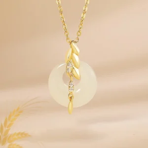 Hetian jade wheat prosperity necklace pendant with cubic zirconia accents on warm background