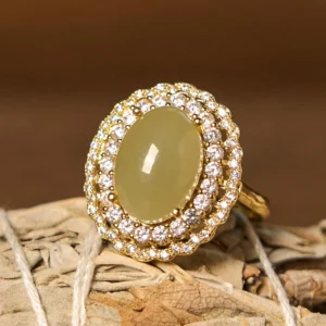 Hetian jade open ring with cubic zirconia halo, front view on natural woven plant background