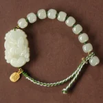 Chinese zodiac Hetian jade bracelet with 925 sterling silver fu charm - overhead flat lay view