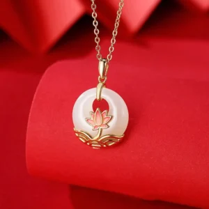 Hetian white jade lotus pendant necklace with 925 sterling silver - front close-up showing delicate white jade with pink enamel lotus detail on red fabric background