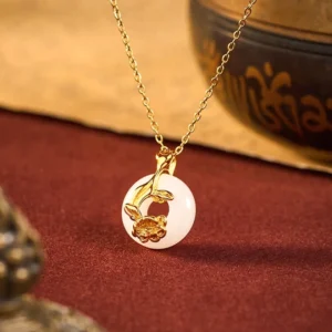 Hetian white jade peace buckle peony necklace with 925 sterling silver pendant on red velvet background, front top-down view showcasing smooth jade and detailed peony carving