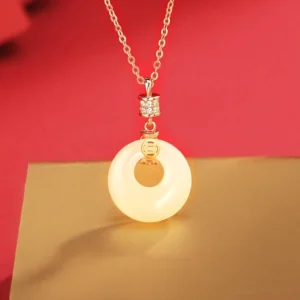 Hetian white jade peace buckle necklace with rose gold sterling silver chain and cubic zirconia bail on luxury display background