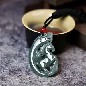 Horse-dragon jade pendant carved in intricate hollow relief, photographed at an oblique angle on a traditional Chinese tea table with black rope and red decorative bead