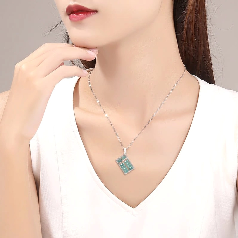 Natural jade abacus pendant displaying the symbolic abacus pattern with movable jade beads and silver-tone metal frame