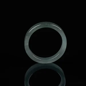 Jade abundance ring front facing view - translucent natural jade circular band on pure black background