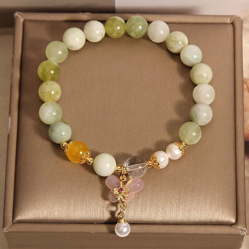 Mixed round and oval jade agate gemstone beads with classic butterfly pendant in brown jewelry tray