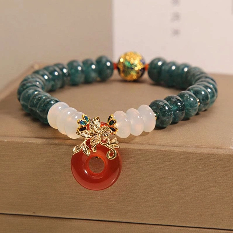 Smooth rondelle white agate beads and glossy red peace buckle jade bracelet detail shot