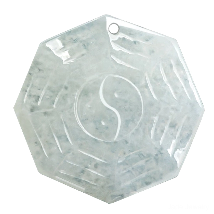 Macro close-up of icy jade Bagua Yin Yang pendant showing precise trigram carving and natural jade texture with blue inclusions