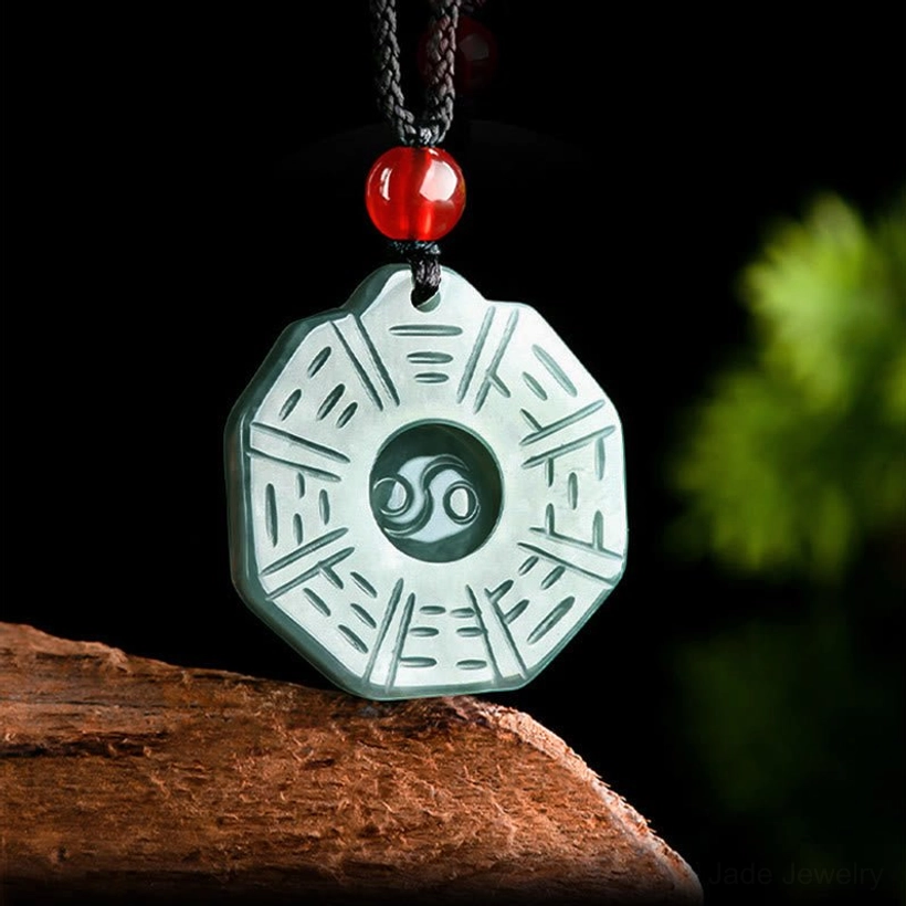 Overhead top-down view of jade Bagua pendant displaying circular Yin Yang center with Bagua trigram lines carved in light green jade