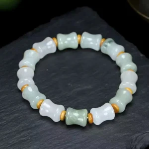 Jade and coconut shell bamboo pattern bracelet with gold metal spacers on dark slate background - handmade elastic stretch bracelet for prosperity