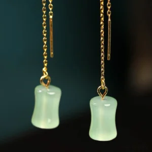 Seafoam green jade bamboo drop earrings with gold copper accents, front close-up view showing detailed jade pendant