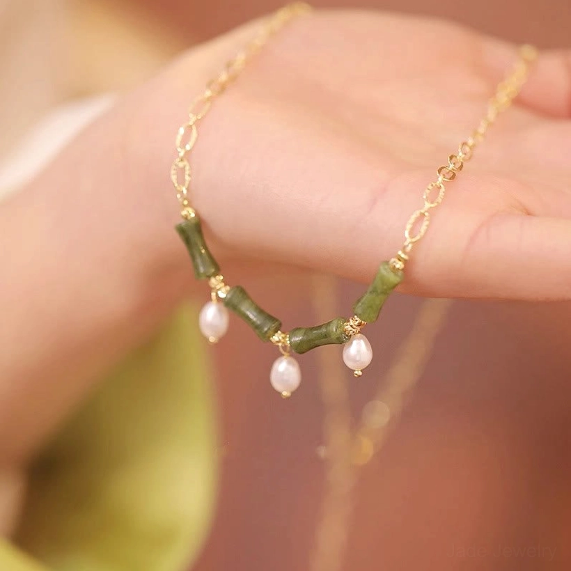 Handmade Tianshan jade bamboo pearl necklace held in palm showing genuine jade pendant and pearl details