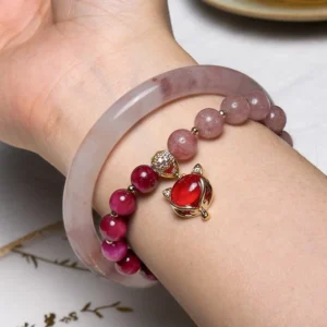 Jade bangle and crystal bracelet worn together on wrist showing natural side profile and daily wear styling