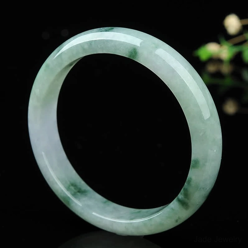 Natural jade bangle bracelet front view displaying classic rounded shape and subtle natural jade texture