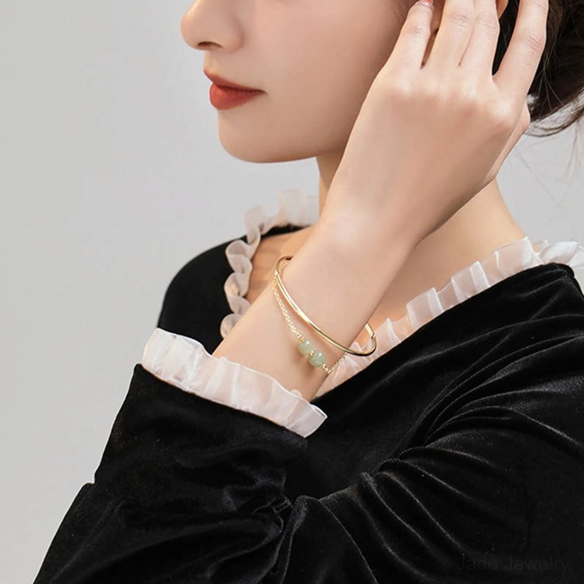 Jade bangle bracelet gift presentation showing double layer design with light green beads in luxury packaging