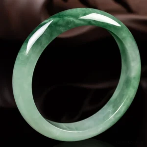 Authentic jade bangle showing side profile with smooth polished edge and natural dark green patterns