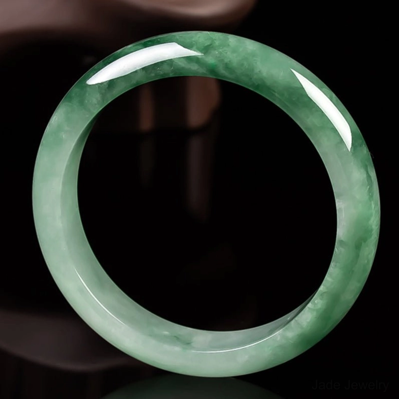 Symmetrical jade bangle bracelet overhead view with even green veining and polished rounded rim