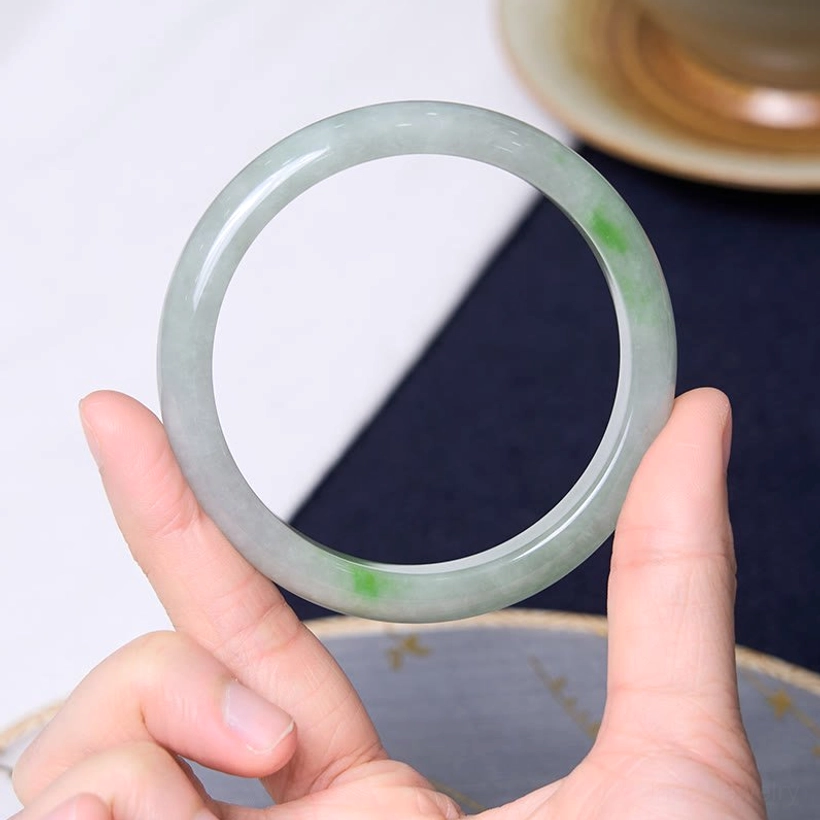 Jade bangle worn on wrist side view demonstrating comfort fit and elegant design