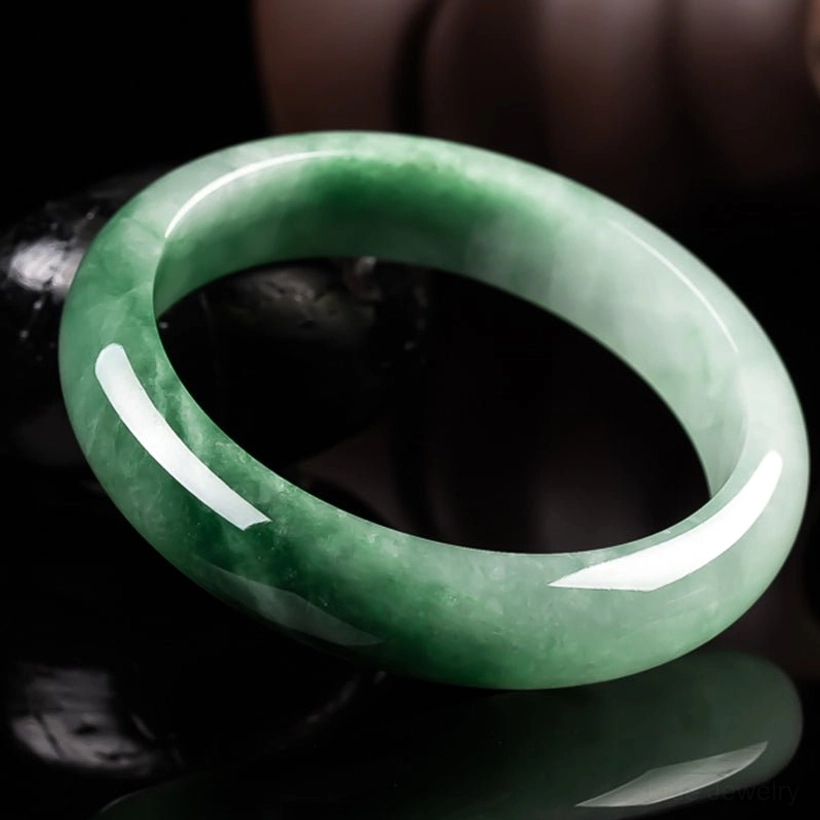 Reflective surface jade bangle bracelet showcasing natural vein patterns and glossy polished jade surface