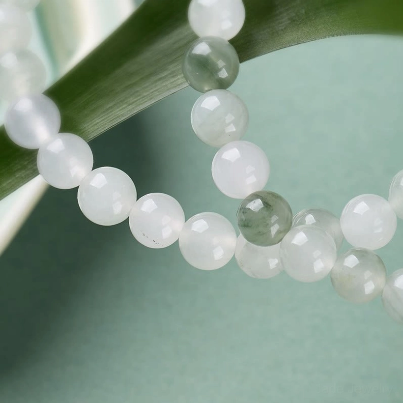 Mixed white and light green jade bead strands with gold metal spacers in bracelet