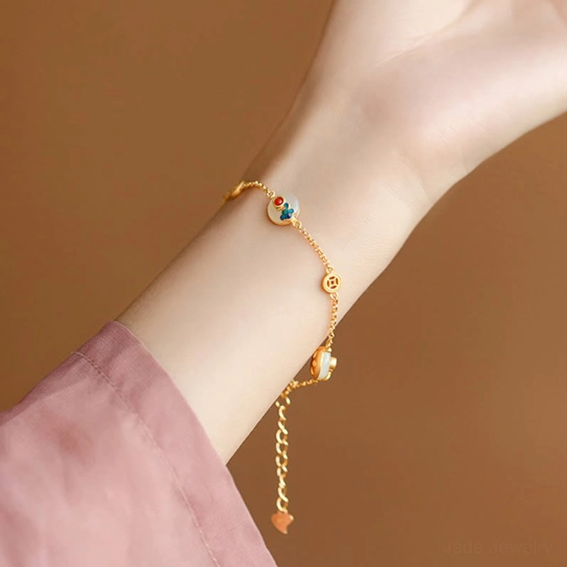 Close-up of Auspicious Clouds Jade Bracelet fastening with gold lobster clasp, branded metal tag, and jade peace buckle
