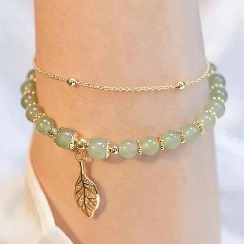 Dark green jade beads bracelet with diamond-studded leaf pendant and gold chains
