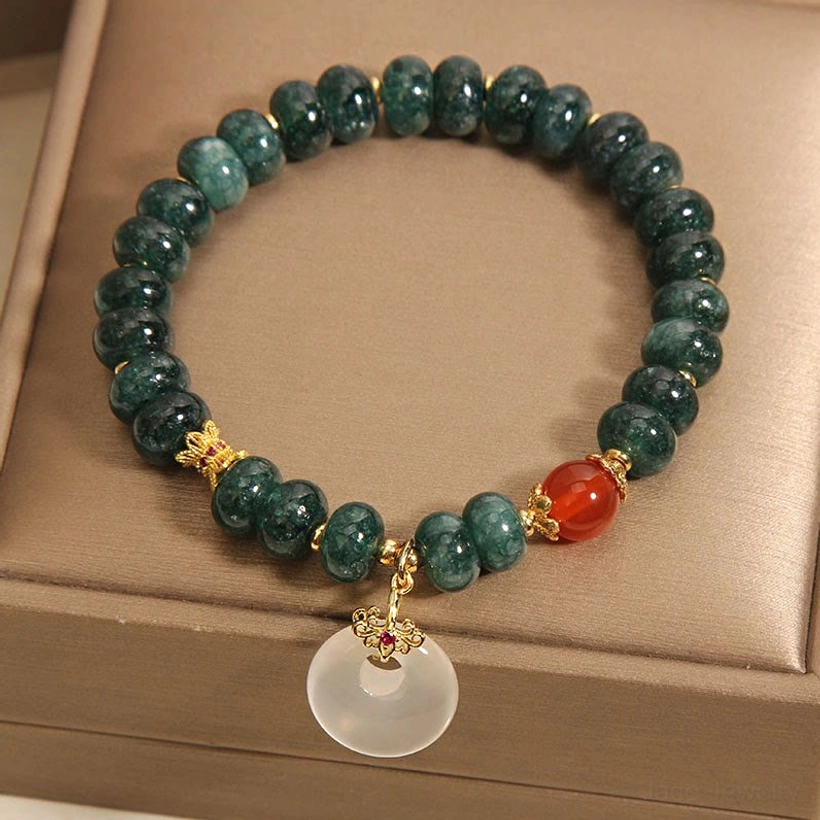 Blue jade beaded bracelet displayed in luxury jewelry gift box, showing white jade peace buckle hanging pendant