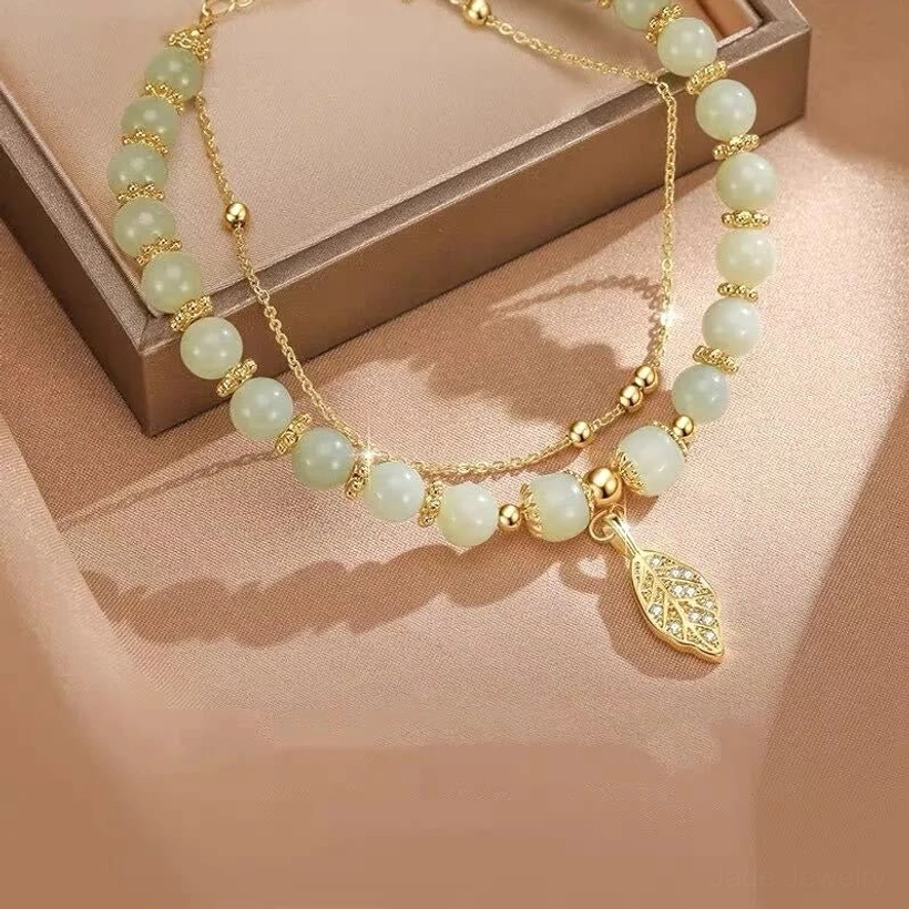 Gradient green-white jade beads bracelet with gold chains in brown jewelry box