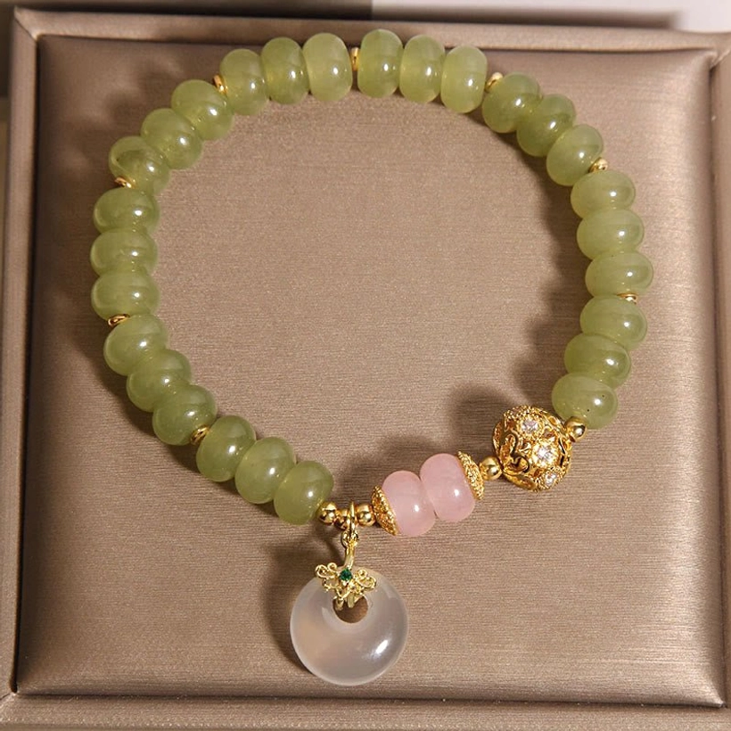 Jade peace buckle bracelet packaged in brown jewelry box showing complete strand with green beads and pink quartz