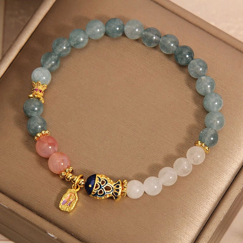 Lucky jade and agate bracelet with koi pendant overhead view showing mixed stone beads arrangement