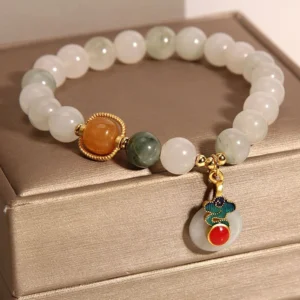 Handmade jade red agate citrine bracelet curved on luxury satin jewelry box lid - detail view