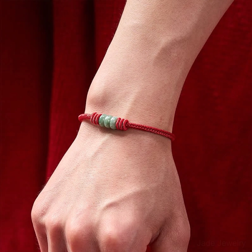 On-wrist demonstration of slim red string jade bracelet with small jade bead set showing natural fit on human wrist