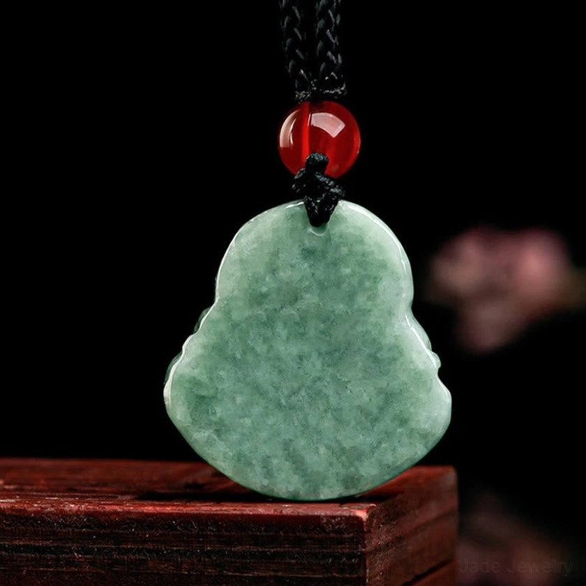 Back view of natural jade Laughing Buddha pendant showing smooth polished flat reverse surface and clean jade edges