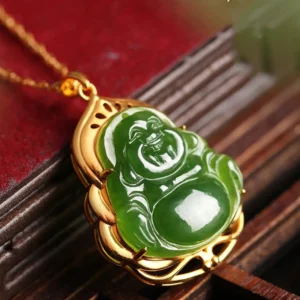 Cyan jade Maitreya Buddha pendant with gold hollow border, side angle close-up showing carved details