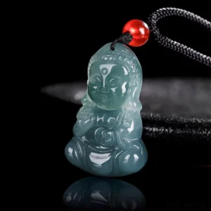 Three-quarter side view of hand-carved jade Buddha pendant showing detailed carving and polished finish