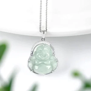 Jade Buddha necklace pendant displayed at side angle with titanium steel curb chain and silver setting on white background
