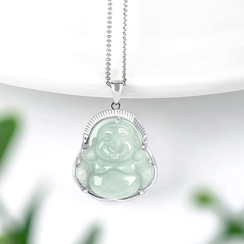 Jade Buddha necklace pendant displayed at side angle with titanium steel curb chain and silver setting on white background