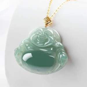 Handcrafted jade Buddha pendant with polished finish and gold decorative clasp on white studio background