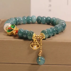 Jade abacus beads prosperity bracelet with gold cloud pendant and teal jade drop charm shown in premium jewelry storage box