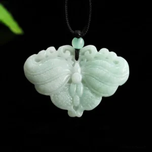 Light green jade butterfly pendant necklace angled view with black cord and decorative leaf detail